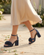 Blue platform sandals with flowers and a chunky heel.