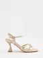Gold thin-heeled sandals with crisscross straps