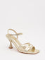 Gold thin-heeled sandals with crisscross straps
