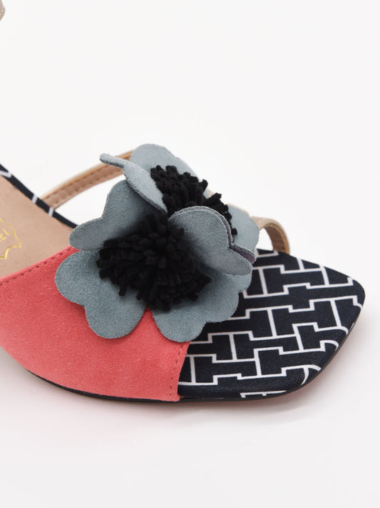 Sandalias coral con tacón ancho, flor decorativa y correa ajustable. Elegantes, cómodas y modernas.