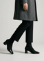 Black heeled ankle boots with patent toe.
