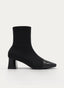 Black heeled ankle boots with patent toe.