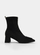 Black ankle boot with wide heel, animal print, and buckle.