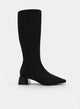 Black high boot with a wide heel and pointed toe.