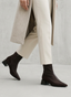 Brown boot with wide heel and patent leather toe.