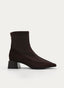 Brown boot with wide heel and patent leather toe.