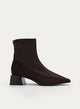 Brown boot with wide heel and patent leather toe.