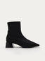 Black ankle boot with wide heel and patent toe.