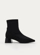 Black ankle boot with wide heel and patent toe.