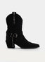 Black cowboy-style boot with buckle.