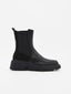 Flat black mid-cut ankle boots in synthetic material with side elastics and robust serrated sole.