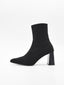 Botín calcetín negro de mujer, de caña elástica ajustada, con tacón ancho cuadrado y punta fina.