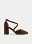 Zapato salón en color marrón con acabado aterciopelado, punta fina y tacón ancho alto. Diseño elegante con tiras cruzadas al tobillo y cierre de hebilla lateral que aporta un estilo sofisticado y femenino ideal para eventos y celebraciones.