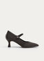Zapato femenino tipo mercedita en color marrón oscuro con dibujo de cuadros en tono contraste. Presenta silueta cerrada, punta fina, tira al empeine con adorno metálico cuadrado y tacón medio tipo copa.